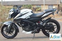 a white and black motorcycle parked on the street