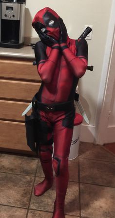 a man in a deadpool costume is holding a knife