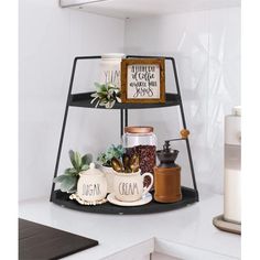 three tiered shelf with coffee mugs and spices