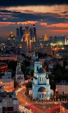 the city skyline is lit up at night