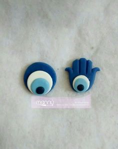 two blue and white ceramic eyeballs sitting on top of a table