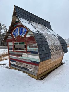 a building made out of wood and metal in the snow