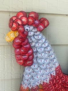 a rooster made out of beer bottle caps