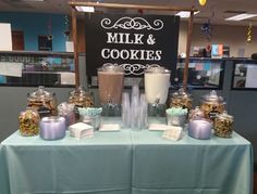 a table topped with lots of different types of cookies and milkshakes on top of it