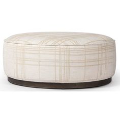 a round ottoman that is made out of fabric