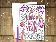 a happy new year card with fireworks, balloons and stars in the background on a wooden surface