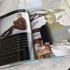 an open book with a photo of a woman in sunglasses on top of a table