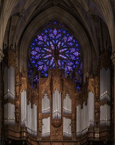 an ornate organ in front of a stained glass window