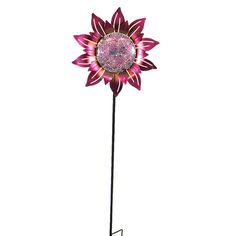 a pink sunflower on a black metal stand with purple glass flowers in the center