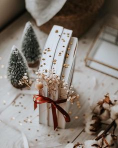 small christmas trees sitting on top of a white table