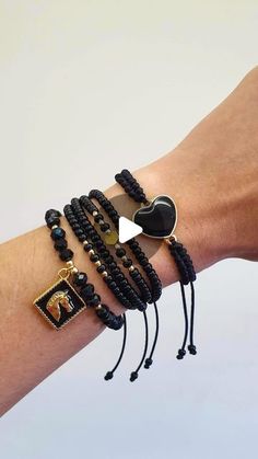 a woman's arm with several bracelets on it and an elephant charm in the middle