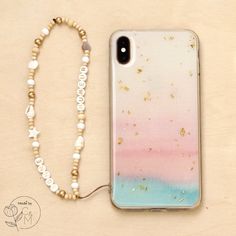 a phone case with a beaded necklace next to it