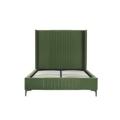 a bed with green upholstered headboard and foot board