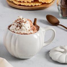 a white mug filled with hot chocolate and whipped cream