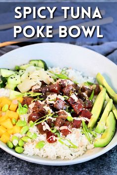 a bowl filled with rice, meat and veggies on top of a table