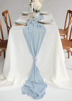 the table is set with white and blue linens