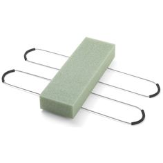 three green sponges sitting on top of two metal rack with hair clips attached to them