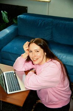 Film photo a young woman works from home, sitting on the floor surrounded by comfortable blue sofas and flowers Blue Sofas, Photography Office, Office Life, Photography Work, Stock Photography Free, Commercial Photography, On The Floor, Photography Business