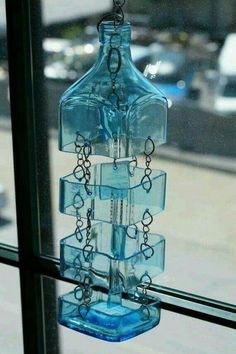 a blue glass bottle hanging from a window