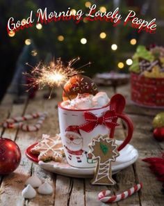 a cup filled with hot chocolate and marshmallows on top of a wooden table