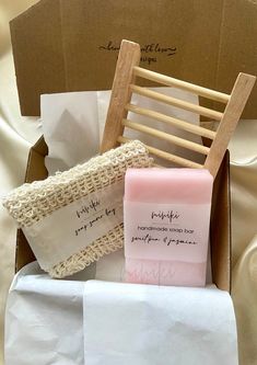 a wooden chair and some paper in a box on a cloth covered tablecloth with writing