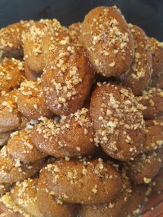 a pile of baked goods sitting on top of a glass plate covered in sesame seeds