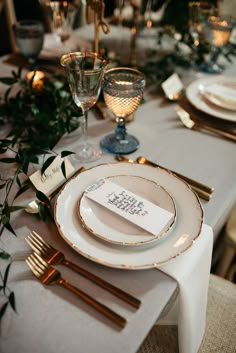 the table is set with place cards and silverware