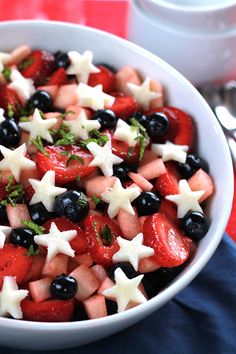 a bowl filled with fruit and stars on top of a table