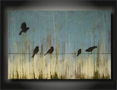 three birds are sitting on a wire in the grass