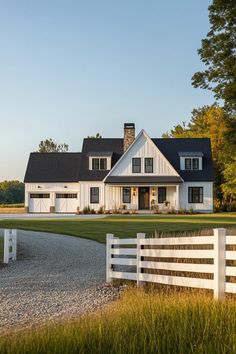 a large white house sitting on top of a lush green field