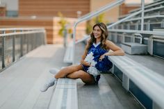 a young woman is sitting on the bleachers