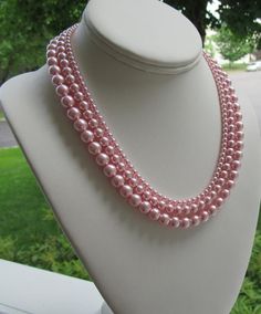 Graduated Pearl Necklace Set ~ This elegant pink pearl necklace set is made with 3 sizes of medium blush pink pearls. A very simple piece to add accent to your wardrobe without overpowering it; whether you are a bride walking down the aisle, or a woman getting ready for a day at the office.  The pink pearls mimic Sarah Jessica Parker's piece, as shown in the last picture and has a classic Jackie O vibe to it.  Earrings shown are included and measure approximately 1".This graduated pink pearl nec Feminine Pink Pearl Necklace, Pink Round Beads Jewelry For Bridesmaid Gift, Feminine Pink Pearl Necklace For Wedding, Woman Getting Ready, Pink Necklace Set, Pearl Necklace Pink, Pink Pearl Jewelry, Bride Walking Down The Aisle, Graduated Pearl Necklace