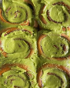 there are many rolls covered in green icing