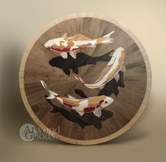 three koi fish swimming in a circular wooden plate with the words always good written on it