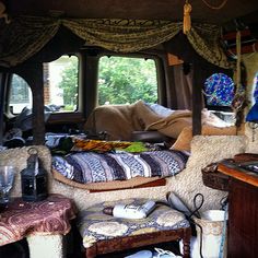 the inside of a van with many items on it and windows open to let in natural light