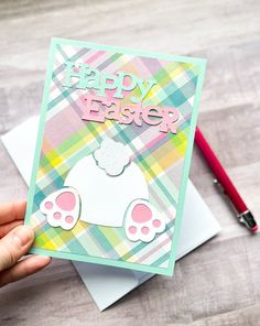 a hand holding up a card that says happy easter