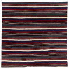 a multicolored striped rug with horizontal stripes on the bottom, and vertical lines at the top