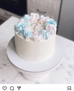 a white and blue cake sitting on top of a table