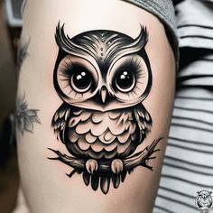 an owl tattoo on the thigh