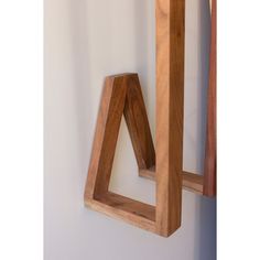 a wooden sculpture is hanging on the wall