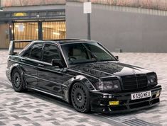 a black car parked in front of a building