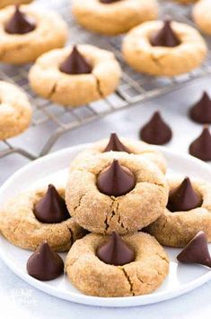 cookies with chocolate chips on a plate and cooling rack in the backgroung