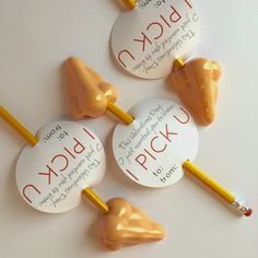 three candy lollipops with writing on them are arranged next to each other