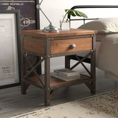 a bed with a wooden night stand next to it