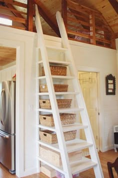 a ladder that is next to a refrigerator