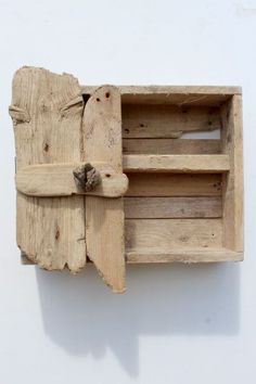 a piece of wood that has been carved into a wall mounted shelf with two open compartments