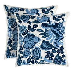 two blue and white pillows with leaves on them