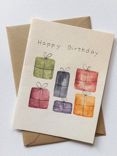 a happy birthday card with watercolor gift boxes