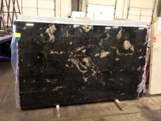 a large black marble slab sitting on top of a floor