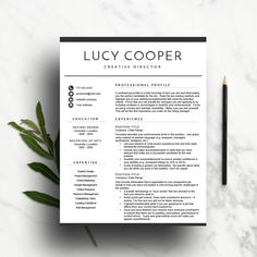 a black and white resume template with a pencil on the side, next to a plant